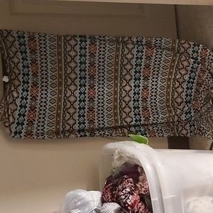 A Semi- Long, Delicate Skirt With A Patterned Design W- Vbrant Orange Blouse